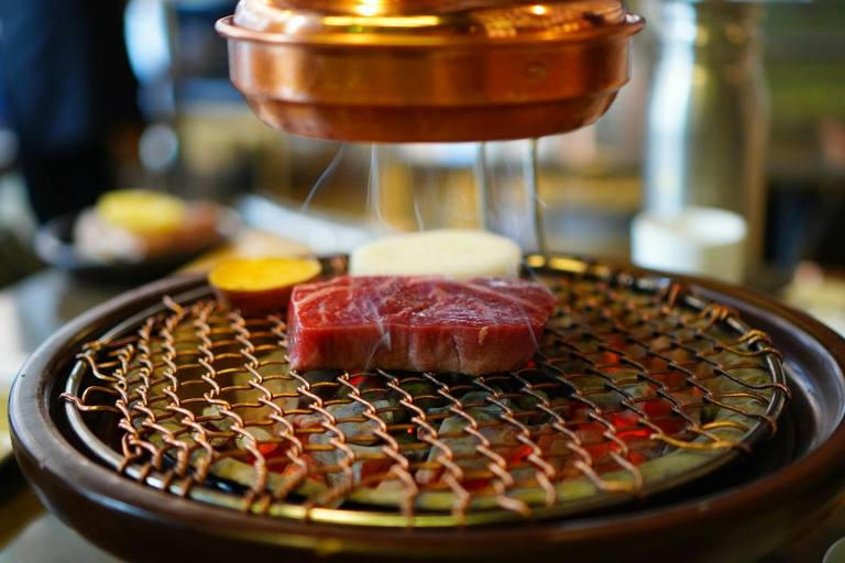 Korean BBQ grill detail with marbled beef